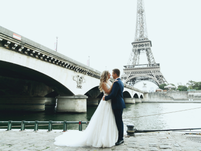 A couple getting married in front of the Seine River in Paris. This is a romantic and beautiful location for your destination wedding.